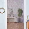 Decorative door string curtains with purple and silver glitter strands covering a window.