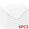 A stack of six white decorative cloth napkins shown from the side.