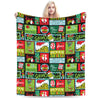 A colorful knitted throw blanket featuring various Halloween-themed graphics and text.