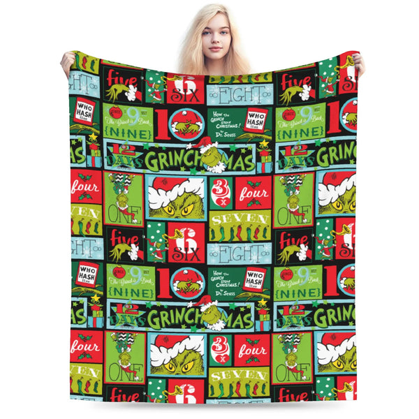 A colorful knitted throw blanket featuring various Halloween-themed graphics and text.