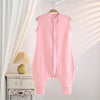 A pink cotton striped sleeping bag for children hanging on a hanger in a bright room.