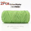 A spool of light green reusable elastic yarn used for crafting.