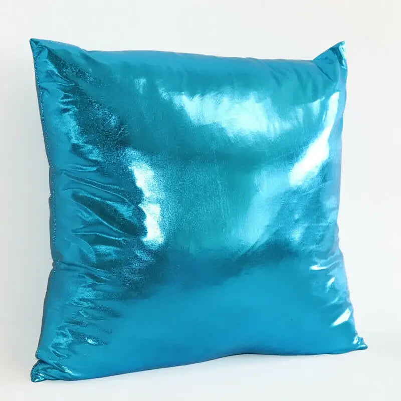 A square pillow cover in a metallic teal blue color with a shiny finish.