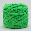 A ball of bright green chenille knitting yarn used for hand crafting.