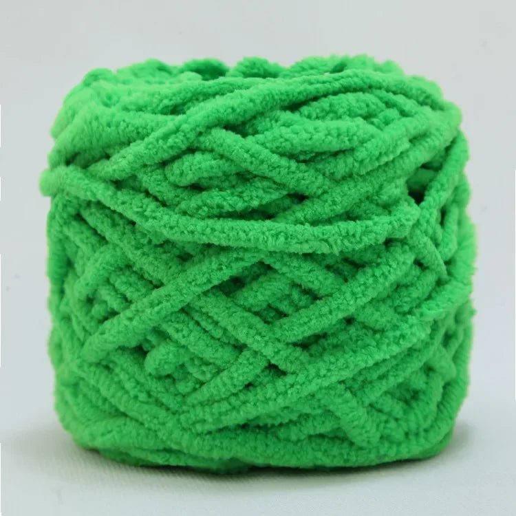 A ball of bright green chenille knitting yarn used for hand crafting.