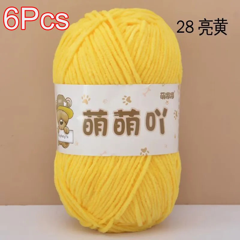 A skein of 6 packs of bright yellow soft bulky chenille yarn for crochet and knitting.
