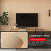 Linen texture self-adhesive 3D thermal insulation wallpaper in a light yellow color on a wall.