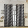 Gray and white tree bark pattern blackout curtains hanging in a light-colored room.