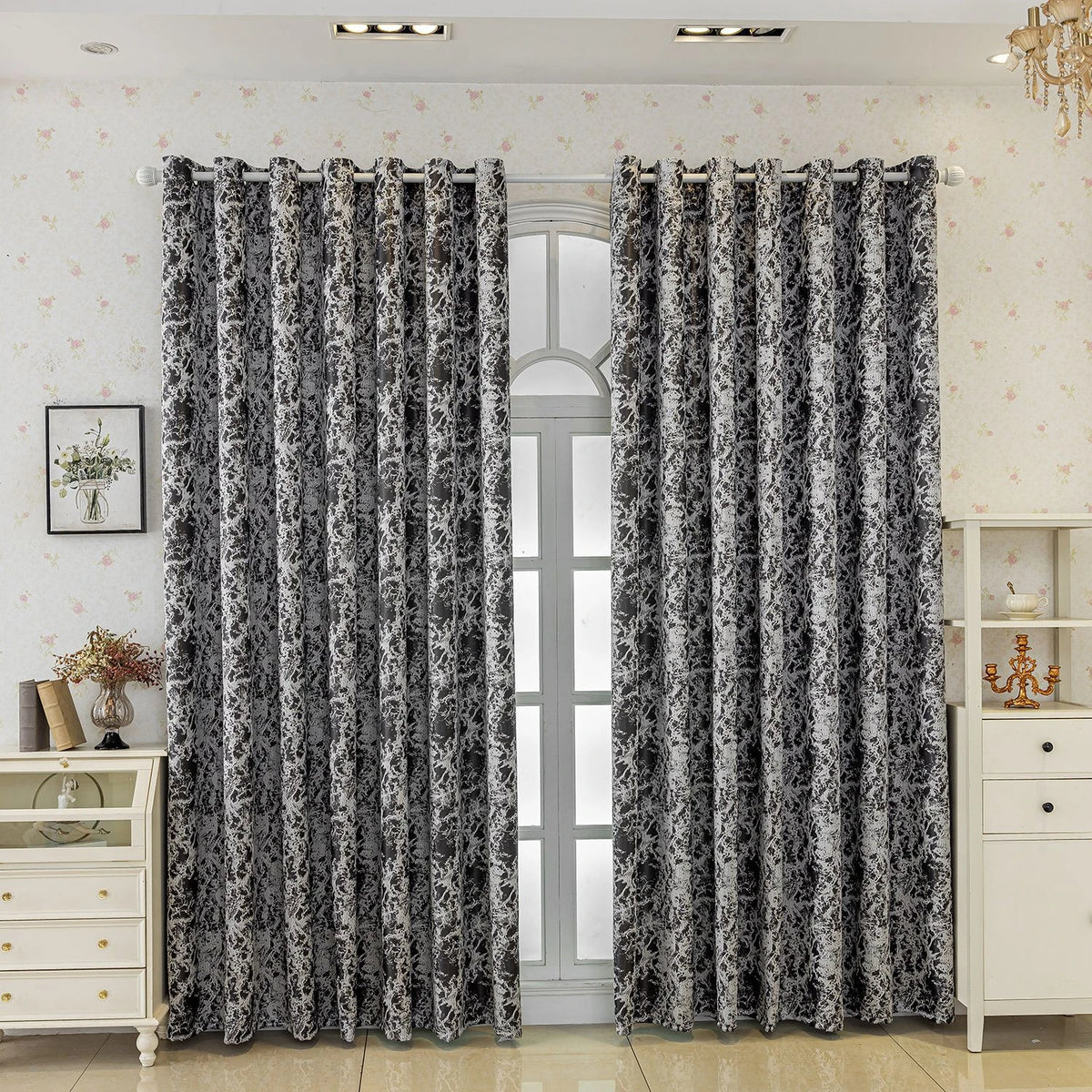 Gray and white tree bark pattern blackout curtains hanging in a light-colored room.