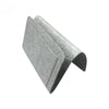 A folded grey felt bedside storage organizer with a hanging pocket.