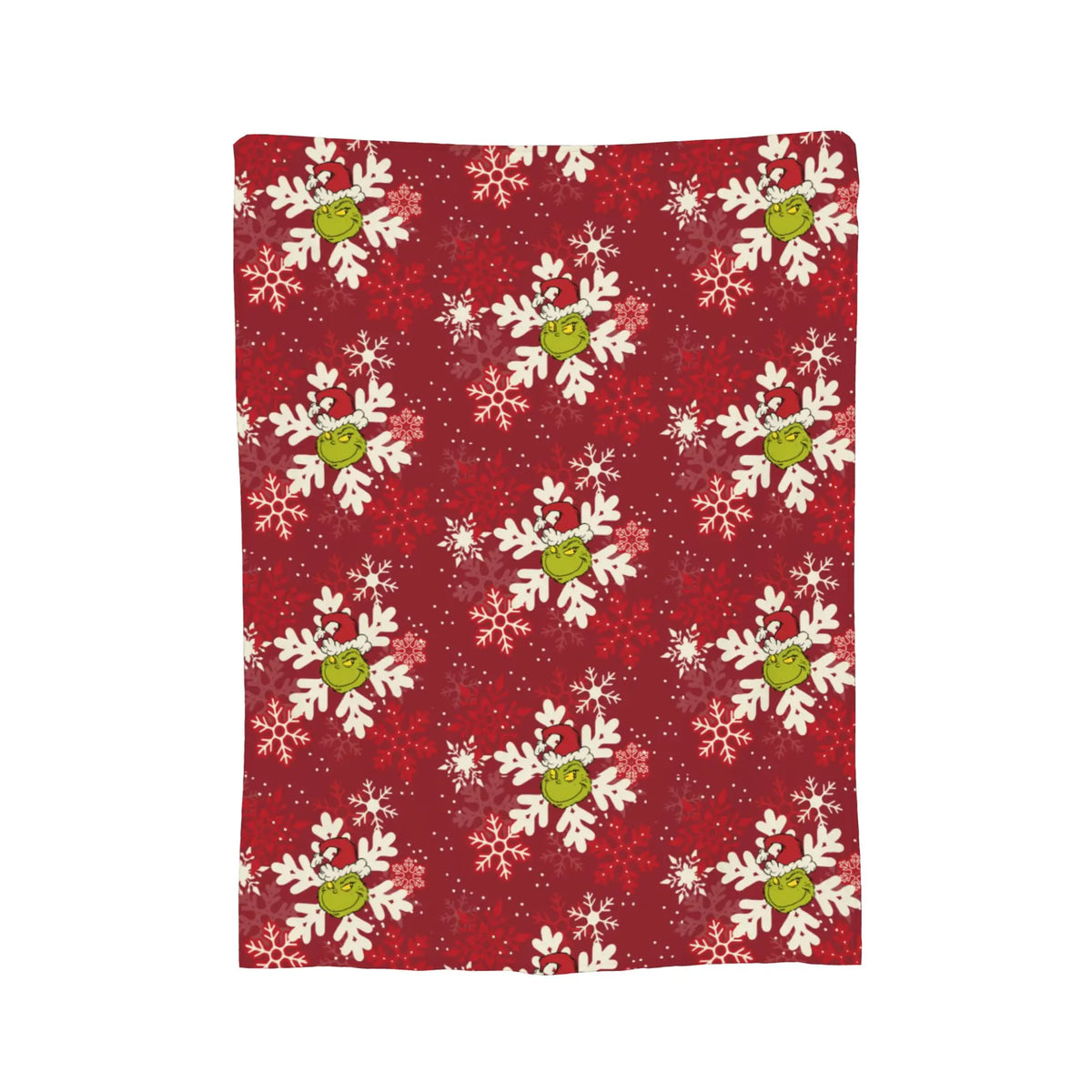 A red patterned throw blanket featuring white and lime green snowflake designs.