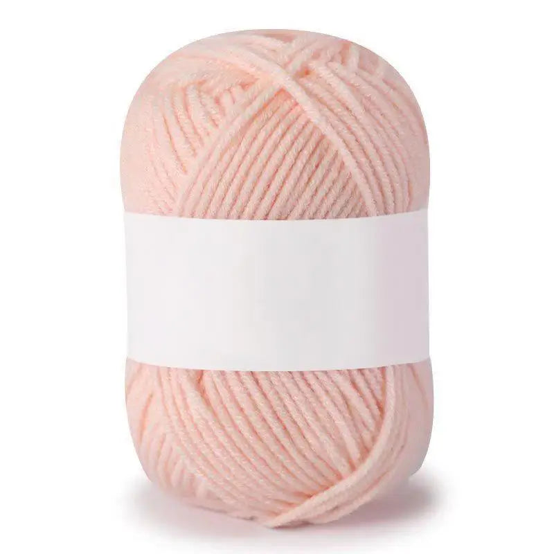 A ball of soft pink milk cotton knitting yarn with white bands.