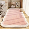 A pink and white striped seasonal decor rug laid out on a wooden floor next to a sofa and decorative items.