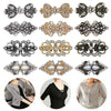 A collection of vintage swirl clip brooches in silver and gold tones displayed against a white background.