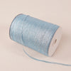 A roll of 10-meter gold and silver glitter satin ribbon with a white core lying on a light fabric.