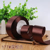 Roll of dark brown satin ribbon for gift wrapping and DIY crafts