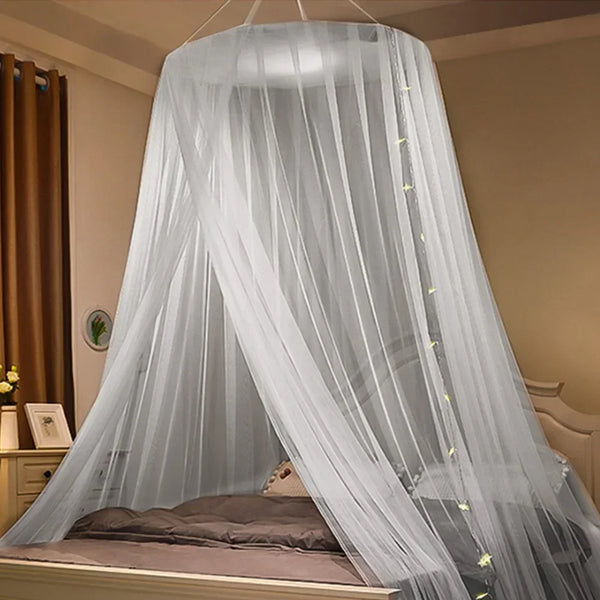 A sheer gray mosquito net canopy draped over a bed, providing a protective covering.