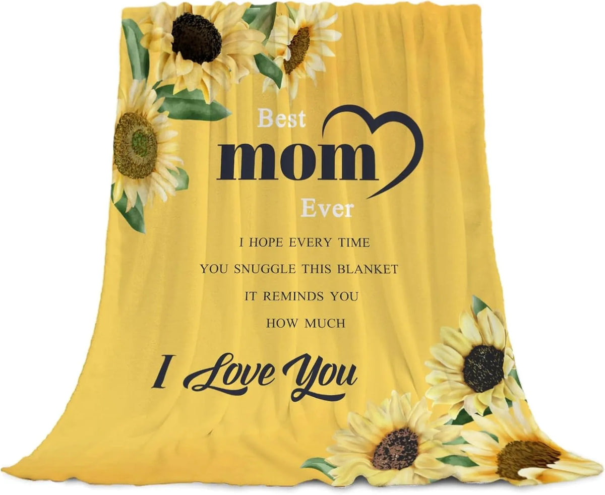 A yellow throw blanket featuring a sunflower print with the text Best mom Ever I hope every time you snuggle this blanket it 