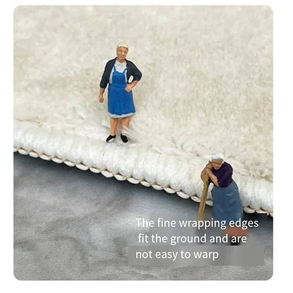 A woman in a blue apron and dark jacket stands on a gray rug, demonstrating the fine wrapping edges that fit the ground and a