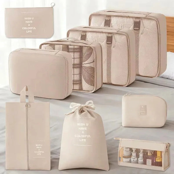A set of beige and cream travel storage organizers including pouches, a toiletry case, and a fabric bag.
