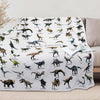 A white flannel throw blanket featuring various Jurassic dinosaurs and prehistoric creatures.