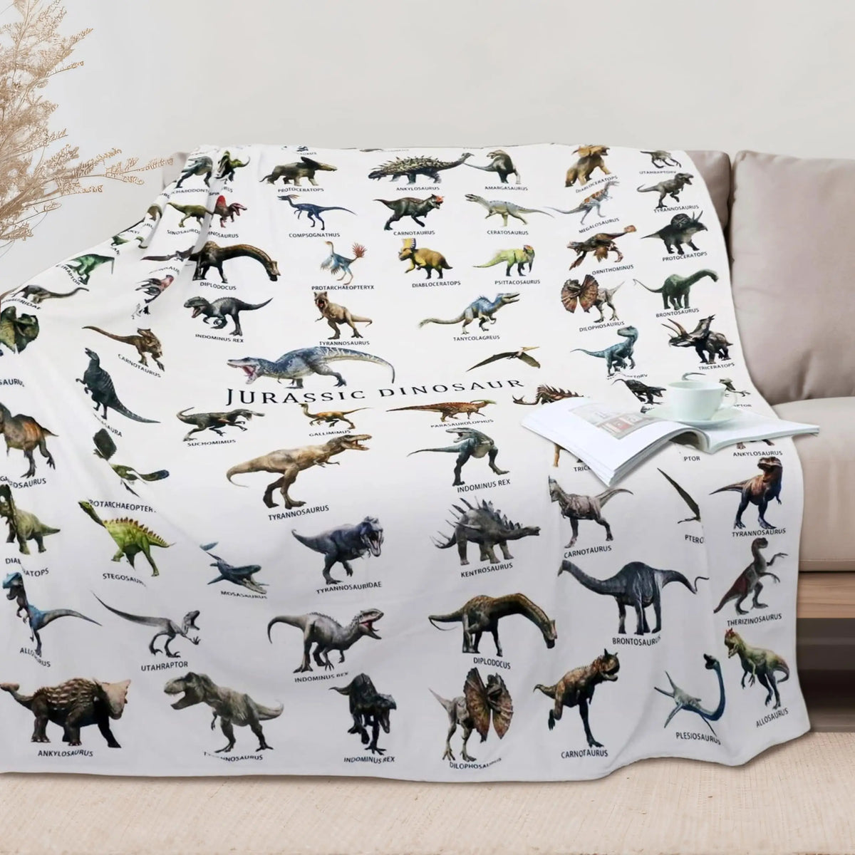 A white flannel throw blanket featuring various Jurassic dinosaurs and prehistoric creatures.