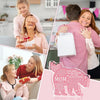 A woman is shown receiving a personalized mom plaque keepsake from another woman in a bright indoor setting.