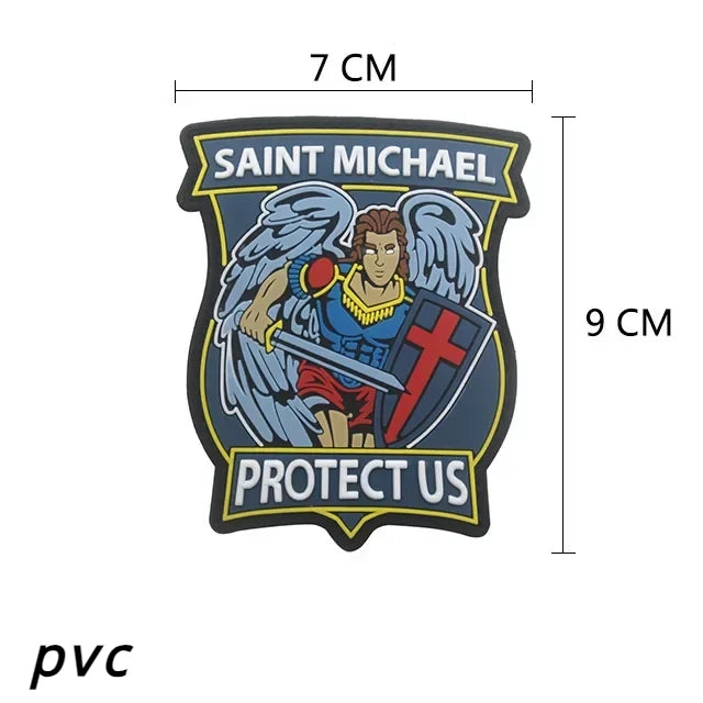 A dark embroidered patch featuring Saint Michael with wings and a shield, with the text Protect Us.