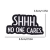 Black embroidery patch with white text reading SHHH. NO ONE CARES.