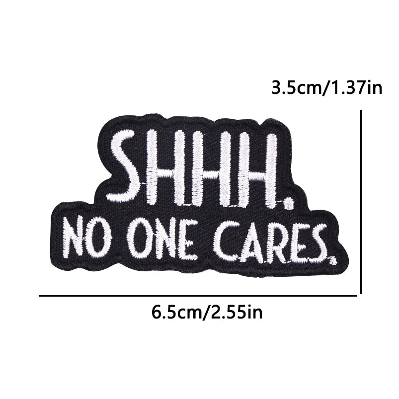 Black embroidery patch with white text reading SHHH. NO ONE CARES.