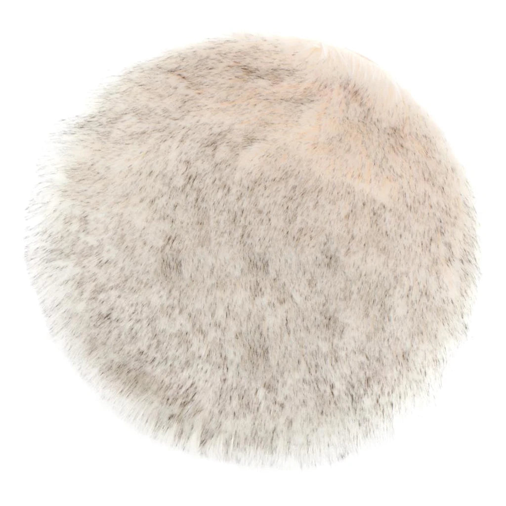 A round rug made of light gray faux fur sheepskin with a plush texture.