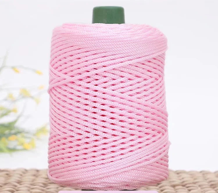 Pink crochet ice rope in a spool with a green cap for DIY crafts