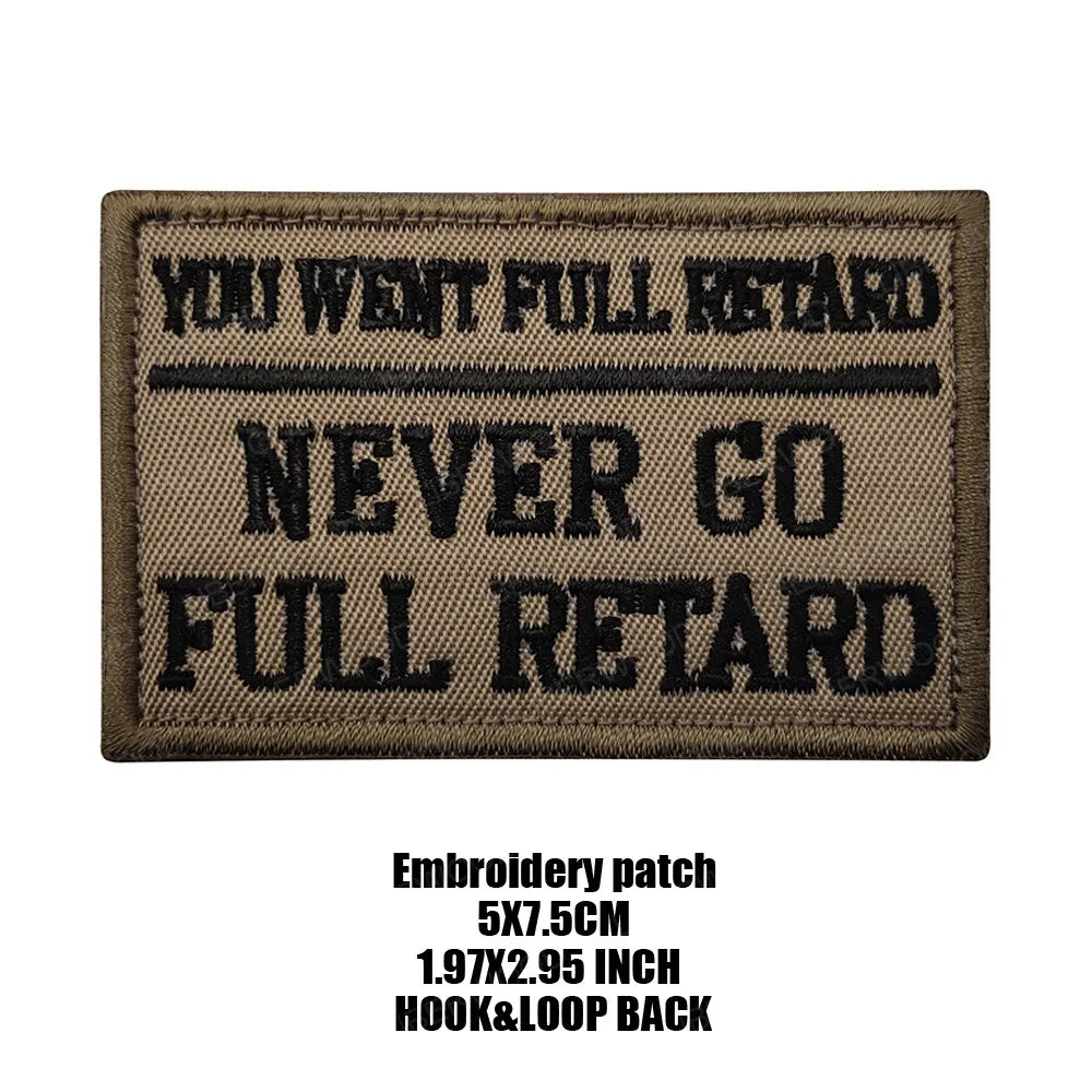 A dark brown embroidered patch with black text that reads You Went Full Retard Never Go Full Retard