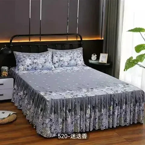 Gray and white patterned fitted bed sheets with elastic lace trim displayed on a bed.