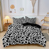 A leopard print duvet cover set featuring black and white spots displayed on a bed.