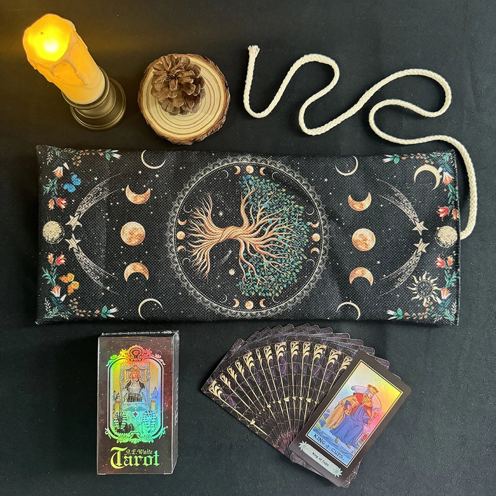 A black storage pouch for a Mystical Tree of Life Tarot card, next to a candle and a deck of tarot cards.
