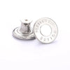 A silver replacement metal button with the words PERFECT FIT BUTTON stamped on it.