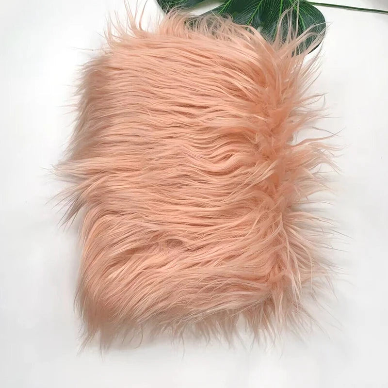 A fluffy, light peach colored faux fur plush fabric for sewing and crafting.