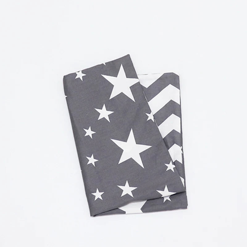 A folded gray and white patriotic fabric featuring stars and stripes pattern.