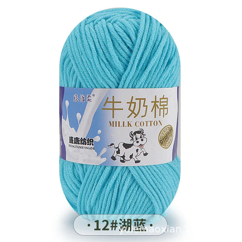 A ball of light blue milk cotton yarn labeled in Chinese and English.