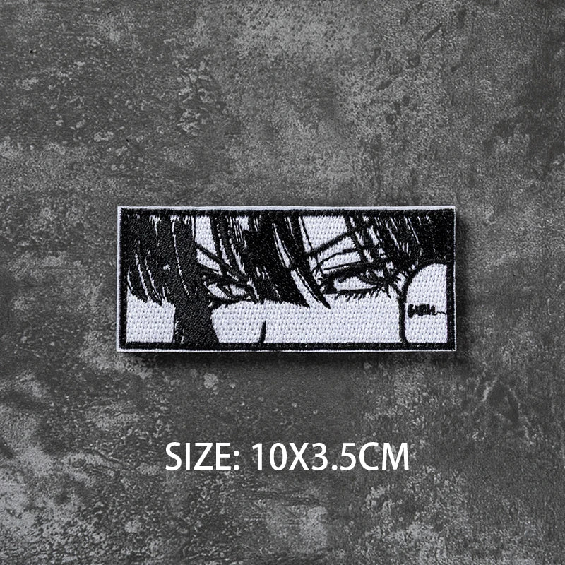A black embroidered patch featuring a silhouette of tree branches on a dark gray textured background.