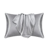 A silver mulberry silk satin pillowcase draped elegantly.