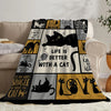 A black and yellow patterned flannel throw blanket featuring cat-themed text and illustrations.