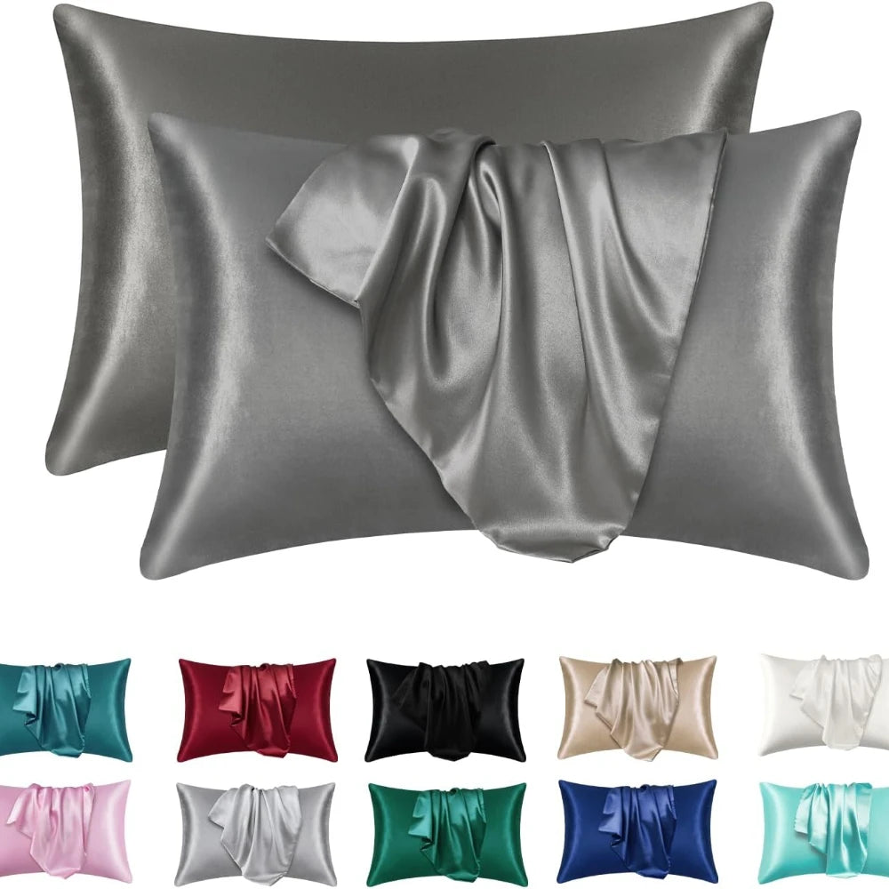 A collection of silky satin pillowcases in various shades including gray, silver, black, red, pink, and green.