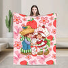 A pink strawberry shortcake plush throw blanket featuring fruit and floral patterns.