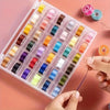A plastic tray of pre-wound sewing machine bobbins in various colors is being handled by a person.