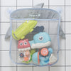 A gray elephant-shaped mesh storage bag filled with colorful bath toys including a yellow duck and blue sea creatures.