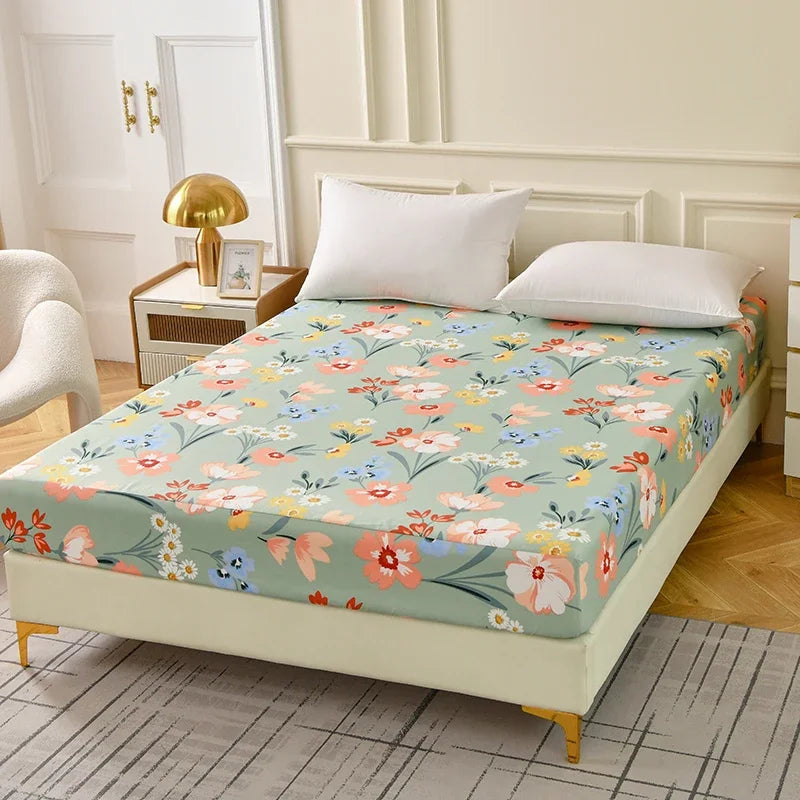 A floral fitted sheet set with pillowcases displayed on a bed, featuring light green and pink flowers.