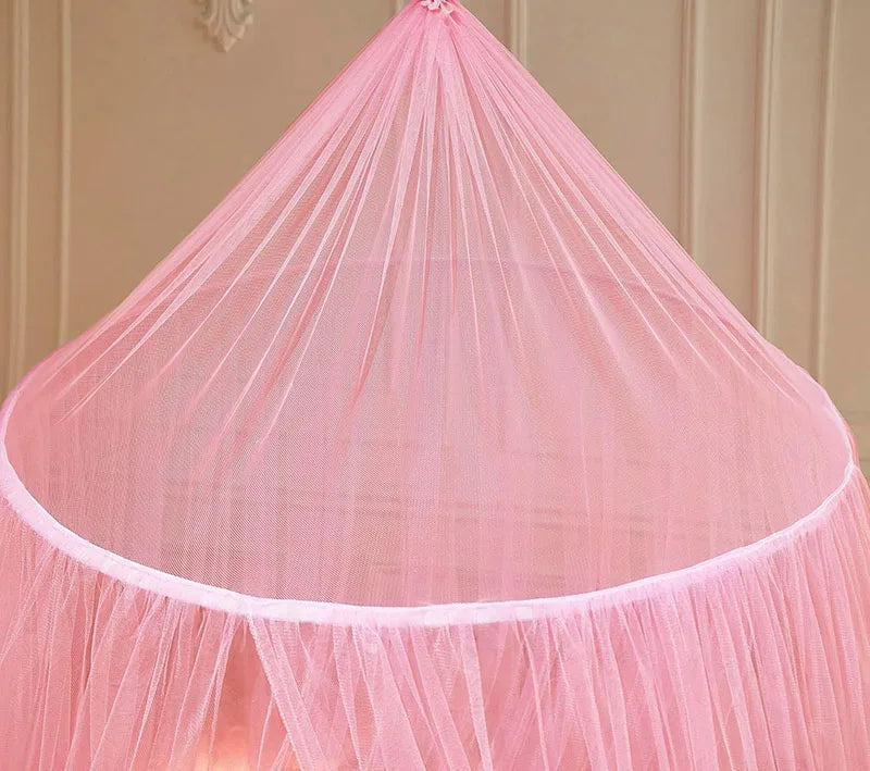 Pink sheer fabric mosquito net canopy with gathered fabric and a round edge