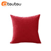 A solid red cushion cover made of soft cotton linen with a button closure.